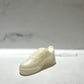 The AF1 – White Lowtop Sneaker Candle – Small (On Backorder) is a white, sneaker-shaped candle, hand-poured and infused with Black Ice fragrance, displayed on a smooth light surface with a blurred background.