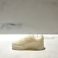 The AF1 – White Lowtop Sneaker Candle – Small (currently on backorder) is hand-poured, possibly scented with Black Ice, and shown on a light surface with a blurred background.