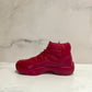 The AJ-11 Red Hightop Sneaker Candle – Large (On Backorder) is a hand-poured, all-natural wax candle shaped like a red high-top sneaker, displayed on a white surface with a light marbled background.