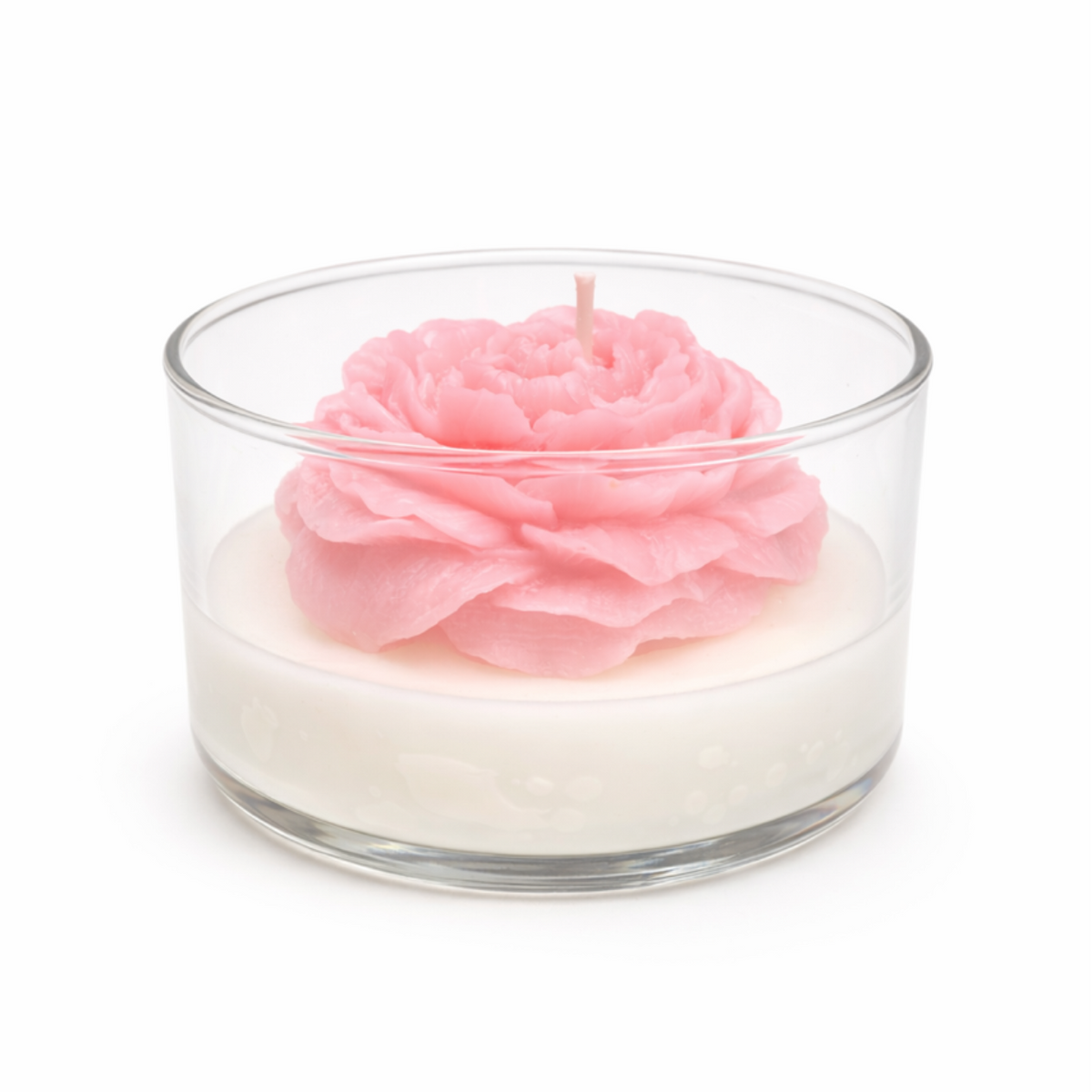 Pink flower-shaped candle in a glass container on a white background