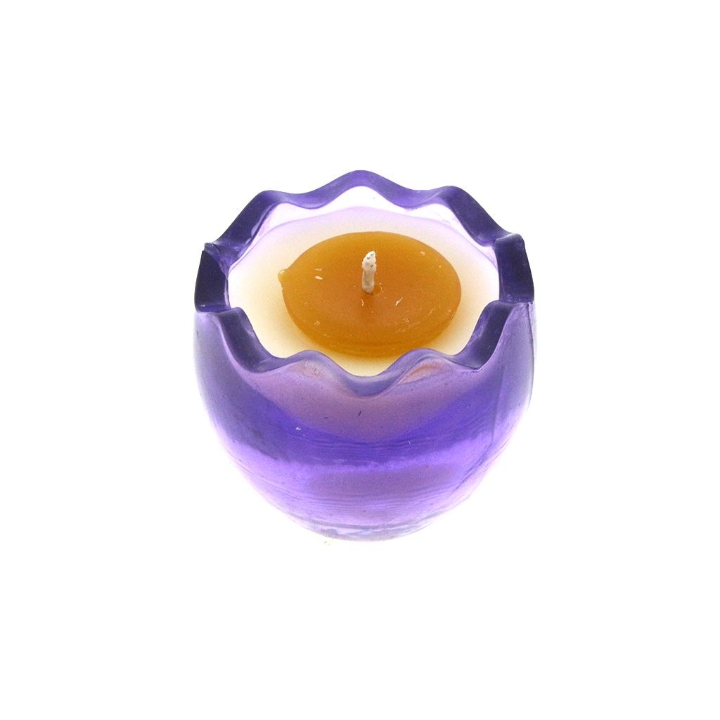 The Purple Glass Easter Egg w/ Yoke features a small, orange, egg-shaped natural wax candle in a round, translucent purple glass holder with a wavy rim.