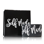The "Self Made" Black Candle Gift Box Set features a black cup and matching candle with "Self Made" in bold white script, and includes a custom candle crafted from natural wax.