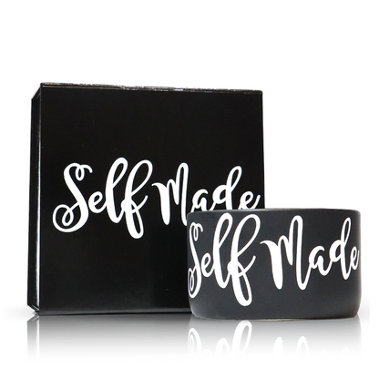 The "Self Made" Black Candle Gift Box Set features a black cup and matching candle with "Self Made" in bold white script, and includes a custom candle crafted from natural wax.
