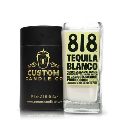 A white "Recycled Azul Agave Blanco Tequila Candle" in a glass sits beside a black Custom Candle Co container with branding and contact info—an elegant addition to the tequila bottle candles collection.