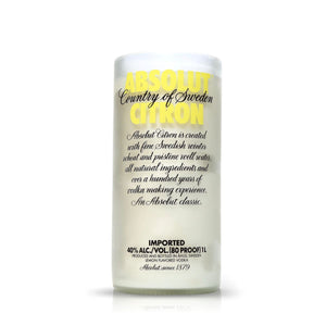 The Recycled Citron Vodka Candle features a frosted glass bottle with yellow and black text, upcycled into an artisanal, eco-friendly candle.