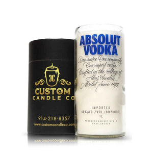 A Recycled Swedish Vodka Candle in a bottle-shaped glass stands next to a black Custom Candle Co. container with gold details, showcasing the brand’s eco-friendly, artisanal craftsmanship.