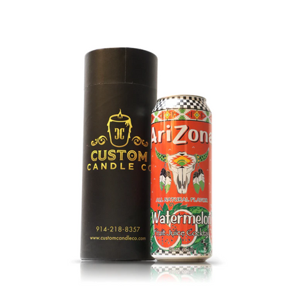 A Recycled Can Watermelon Candle stands next to an Arizona Watermelon Fruit Juice Cocktail can against a white background.