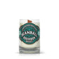 Recycled Bourbon Whiskey Candle: An elegant glass candle with a wooden wick, featuring teal and black branding on the front—crafted from an upcycled whiskey bottle for a unique touch.