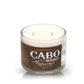 The Recycled Azul Agave Anejo Tequila Candle is crafted from a repurposed "Cabo Wabo Tequila Añejo 100% Agave Azul" bottle, featuring two wicks and a brown and white design.