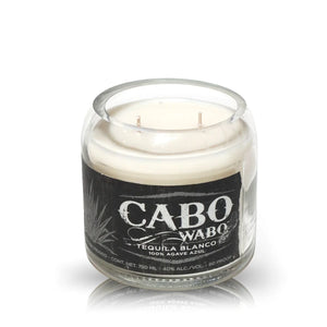 The Recycled Azul Agave Tequila Candle is a white soy candle in a clear glass with a black label reading "Cabo Wabo Tequila Blanco, 100% Agave Azul." Ideal for fans of unique tequila-inspired decor.