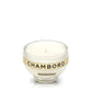 A Recycled Loire Valley Liqueur Candle in a glass holder labeled "CHAMBORD," made from upcycled liqueur bottles with a white candle inside, is displayed against a plain white background.