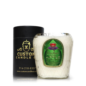The Recycled Apple Whiskey Candle by Custom Candle Co. features coconut apricot wax in a glass container with a green Apple label, shown beside its sleek black cylindrical packaging.