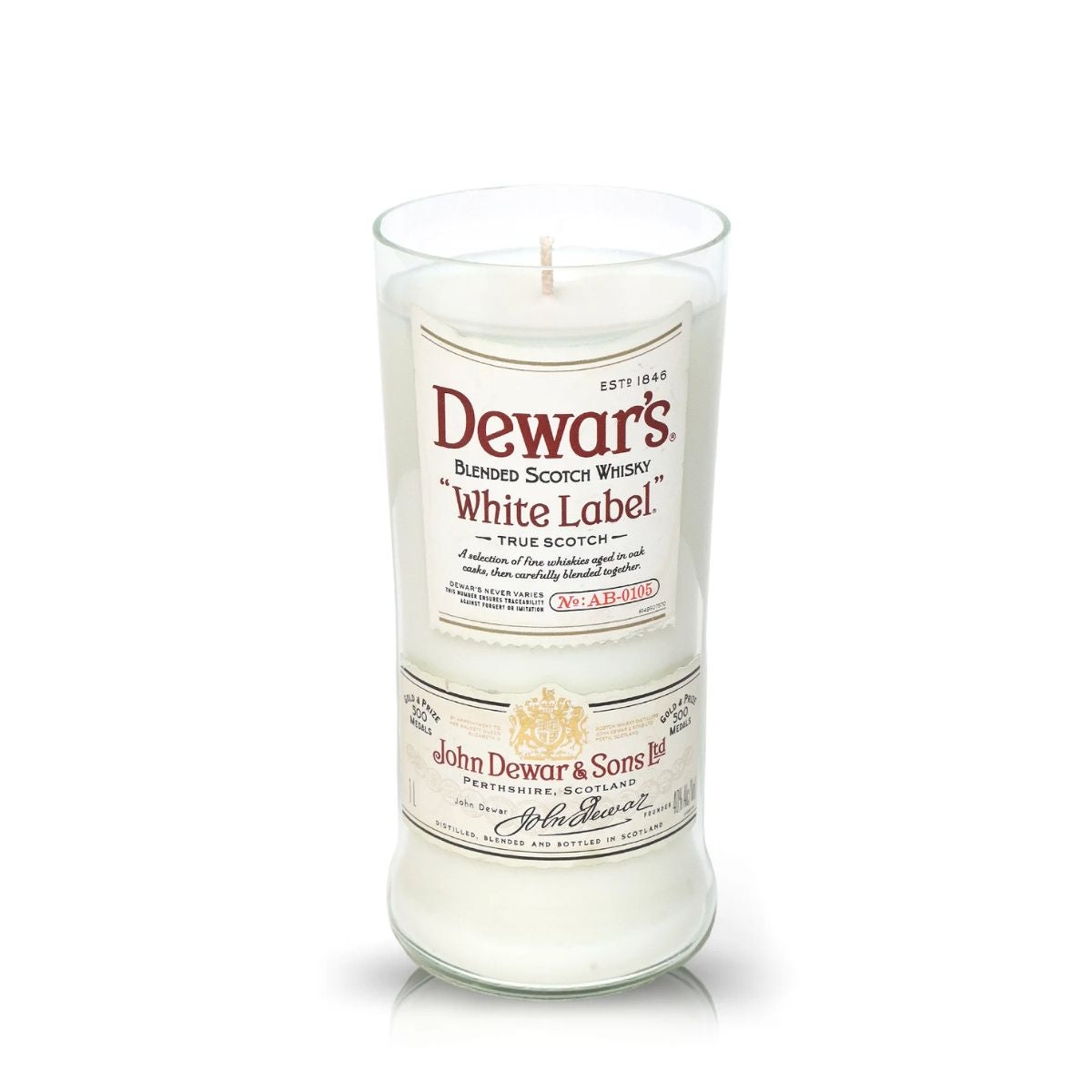 The Recycled White Label Scotch Whiskey Candle is a white candle in a clear glass holder made from upcycled whiskey bottles and labeled Dewar's White Label Blended Scotch Whisky.