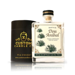 A Recycled Reserva Reposado Tequila Candle in a black cylindrical Custom Candle Co. container, made from a recycled tequila bottle, is displayed with a label featuring agave plants and product details.