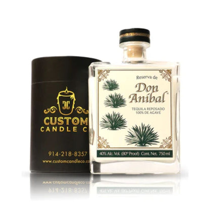A Recycled Reserva Reposado Tequila Candle in a black cylindrical Custom Candle Co. container, made from a recycled tequila bottle, is displayed with a label featuring agave plants and product details.