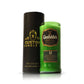 A Recycled Green Scotch Whiskey Candle sits beside a black cylindrical container labeled "Custom Candle Co.