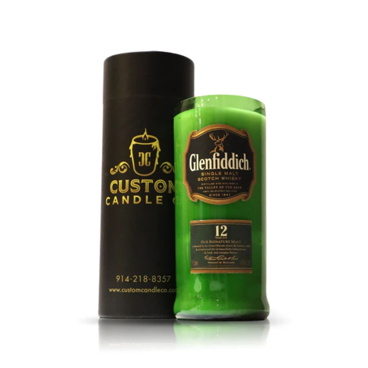 A Recycled Green Scotch Whiskey Candle sits beside a black cylindrical container labeled "Custom Candle Co.