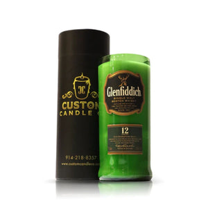 A Recycled Green Scotch Whiskey Candle sits beside a black cylindrical container labeled "Custom Candle Co.