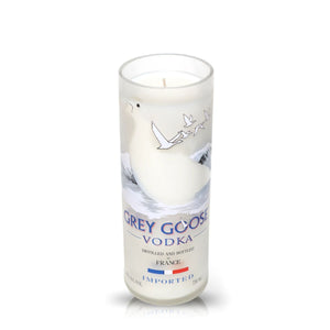 The Recycled French Vodka Candle - White features a white candle in a repurposed Grey Goose bottle with the logo and goose graphic, ideal for eco-friendly candle lovers or collectors of unique vodka bottle candles.