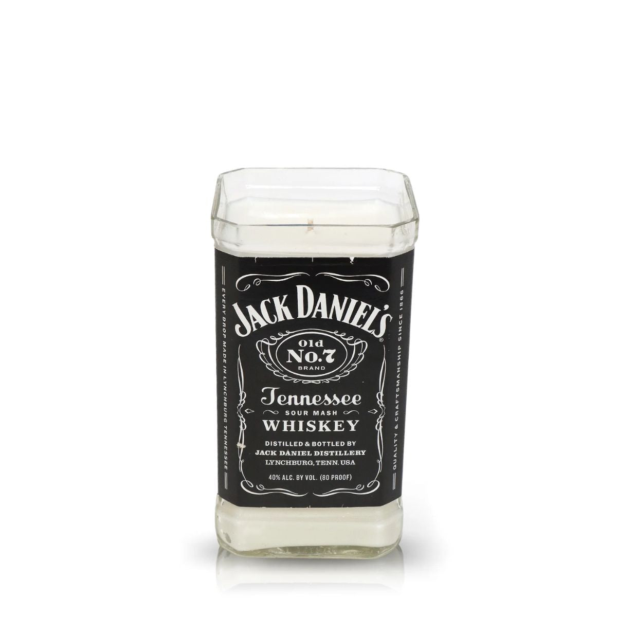 The Recycled Sour Mash Whiskey Candle is an upcycled glass candle shaped like a Jack Daniel's Old No. 7 bottle, made with eco-friendly coconut-apricot wax for a unique, sustainable touch.