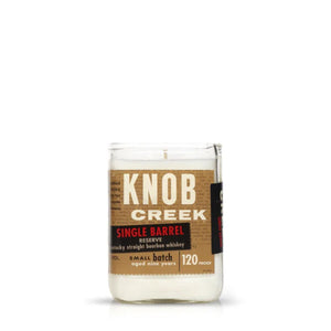 The Recycled Single Barrel Whiskey Candle is a white candle in a glass jar made from upcycled whiskey bottles, labeled "Knob Creek Single Barrel Reserve, Kentucky Straight Bourbon Whiskey, 120 proof.