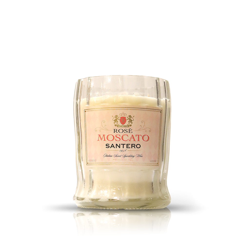 A candle in a clear glass container made from an upcycled wine bottle, featuring a "Recycled 1958 Rose Wine Candle" label on the front.