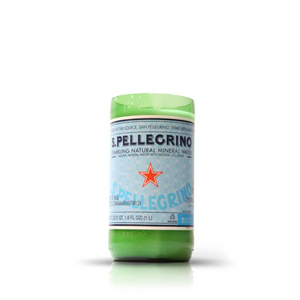 The Recycled Sparkling Natural Mineral Water Candle is handmade from the lower half of a repurposed S.Pellegrino bottle with its original label, making it an eco-friendly and stylish candle holder.