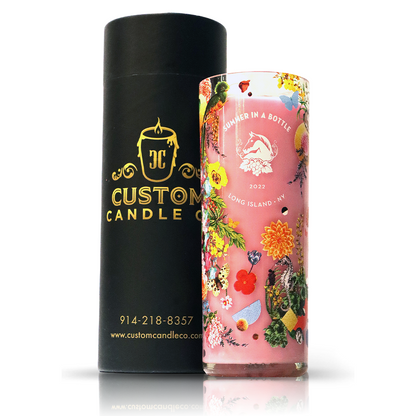 The Recycled Summer Pink Wine Candle, featuring a floral "Summer in a Bottle 2022 Long Island, NY" label, stands beside a black Custom Candle Co. box—a stylish, eco-friendly accent for any space.