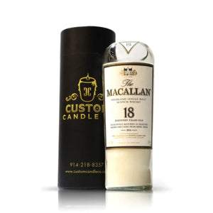 The Recycled Highland Single Malt Scotch Whiskey Candle, crafted in a glass inspired by Macallan 18, sits next to a sleek black Custom Candle Co. box—ideal for whiskey candle enthusiasts.