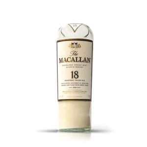 A Recycled Highland Single Malt Scotch Whiskey Candle, crafted from a partially emptied bottle—perfect for upcycled décor—stands upright against a plain white background.