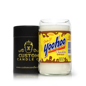 A Recycled Chocolate Milk Glass Candle stands next to a black Custom Candle Co. container, showcasing eco-friendly candles that enhance your home decor.