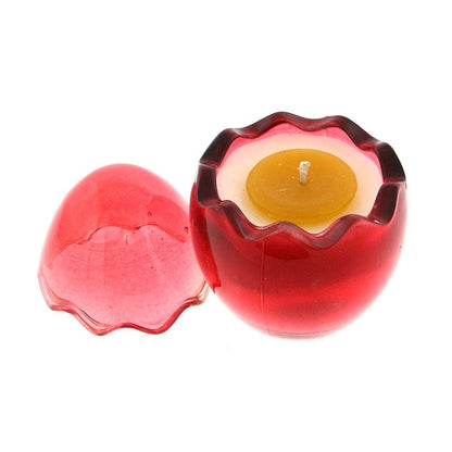 The Red Glass Easter Egg w/ Yoke is a red, translucent, egg-shaped candle holder with a removable lid, containing a yellow natural wax candle infused with a Peeps fragrance.