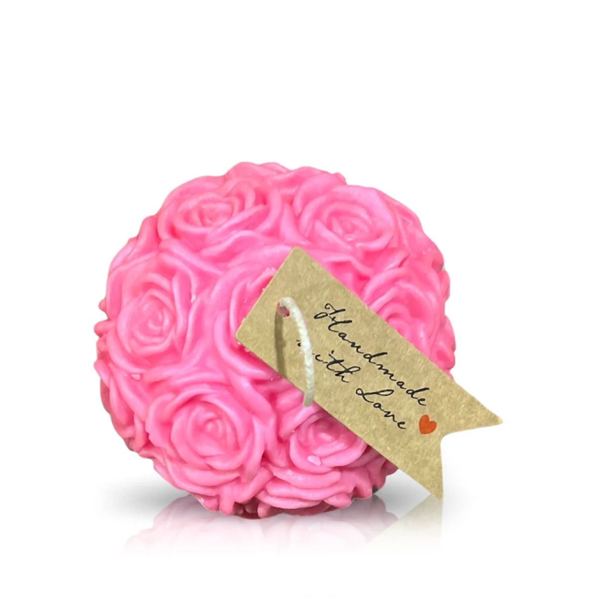 The Pink Pastel Rose Candle is round, pink, and adorned with delicate rose patterns. It features a brown tag labeled "Handmade with love" and is accented by a small red heart.
