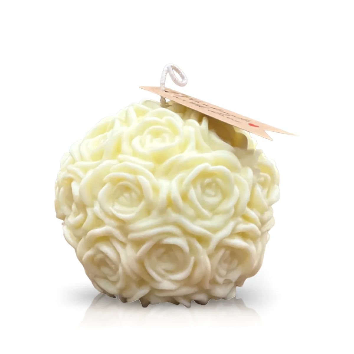 The Yellow Pastel Rose Candle is a round, yellow soy candle with a rose-textured surface and tag on the wick—ideal as a decorative rose-scented accent for any space.