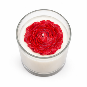 The Rose Blossom Candle is a handcrafted, all-natural soy candle in white, topped with a red wax rose and presented in a glass container.