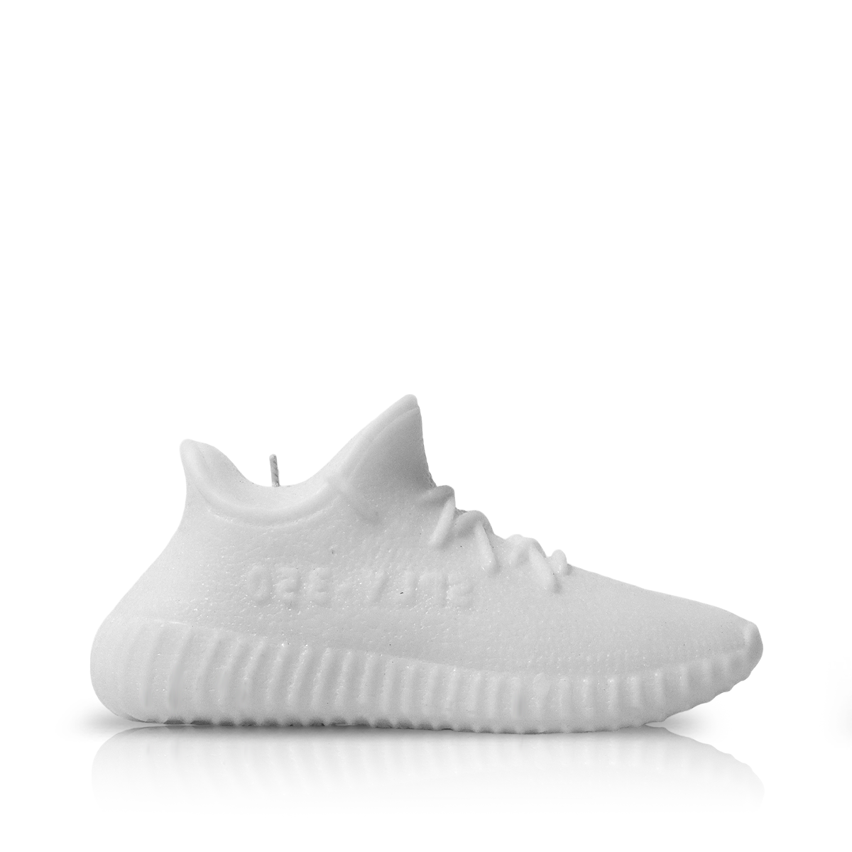 A Yeezy 350 Sneaker Candle (On Backorder), shaped like a white sneaker with laces and a textured sole, is shown against a plain white background.
