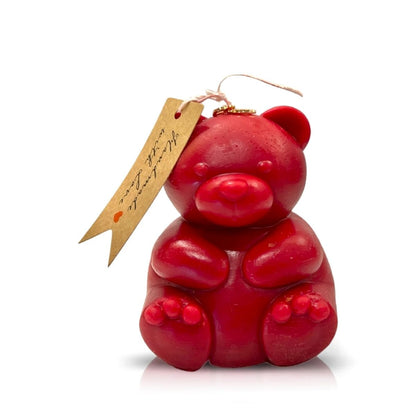 The Teddy Bear Red Chubby Candle is a natural wax candle shaped like a teddy bear, featuring a string and brown tag on its ear—an adorable Valentine’s Day gift, shown on a white background.