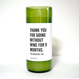 The "Thanks for Going Without Wine for 9 Months" candle is a green recycled wine bottle with a white label—an ideal soy candle gift to celebrate any new mom and acknowledge her dedication.