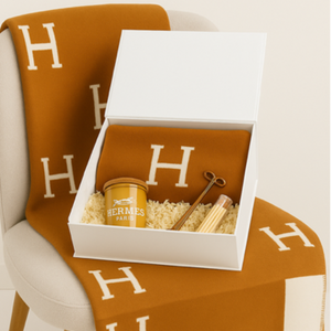 The Orange Paris Designer Gift Set includes a brown and white Hermes cotton throw, matching gift box, scented candle, wick trimmer, and lighter—ideal for custom design baskets or gifting.