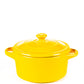 The Yellow Mini Cereal Crockpot Candle is a fruity scented soy candle in a yellow ceramic dutch oven with handles and lid, ideal for a charming mini cereal crockpot candle experience.