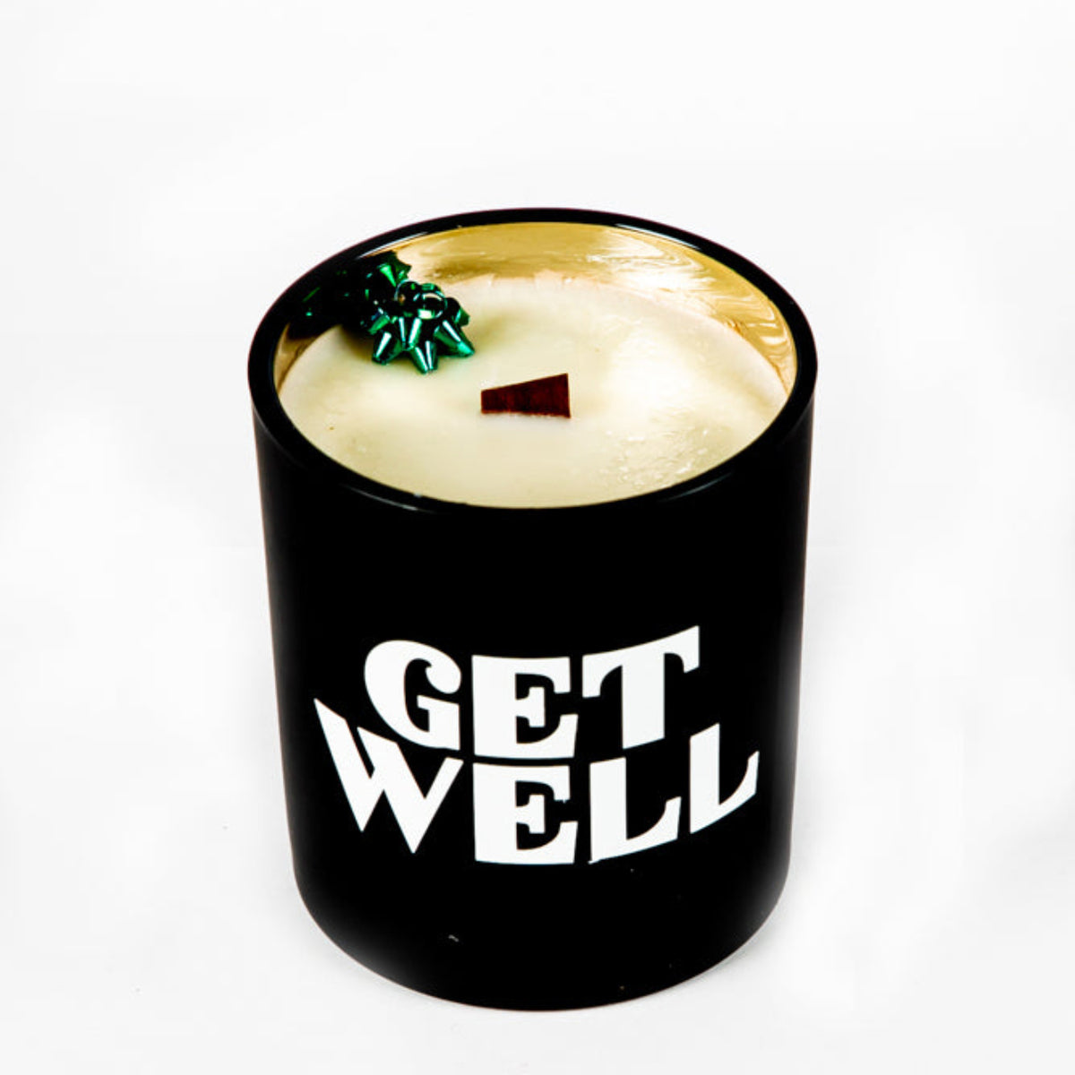The "Get Well" Candle Gift Box Set includes a black holder with "GET WELL" in white lettering, a cream-colored natural wax candle, and a small green decorative accent—perfect for a thoughtful get well gift.