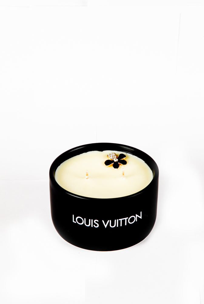 The LV Candle Designer Gift Set features a black soy wax candle with two wicks and a decorative flower on top, shown against a plain white background.