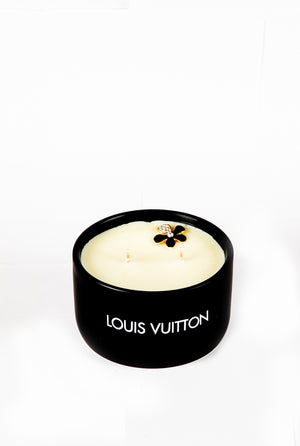 The LV Candle Designer Gift Set features a black soy wax candle with two wicks and a decorative flower on top, shown against a plain white background.