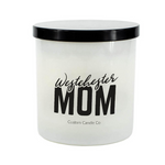 The Westchester Mom White Glass Candle is a hand-poured soy candle with a black lid, labeled "Westchester Mom" and "Custom Candle Co." It’s a thoughtful gift or a cozy addition to any home.