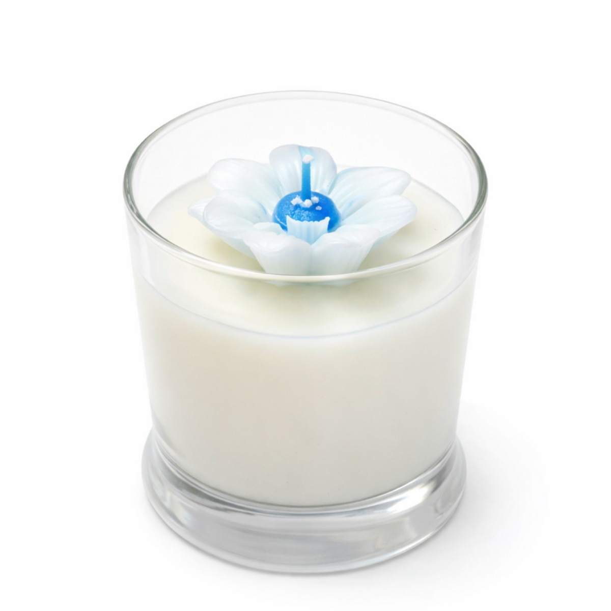 White candle with a white flower on a white background