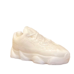 The Y500 – White Sneaker Candle – Large (On Backorder) is a hand-poured candle with visible laces and textured details, shown against a plain background.