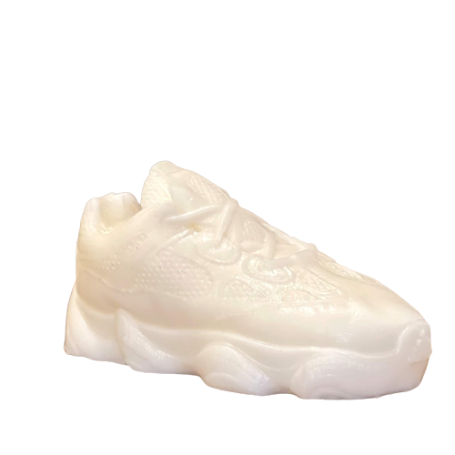 The Y500 – White Sneaker Candle – Large (On Backorder) is a hand-poured candle with visible laces and textured details, shown against a plain background.