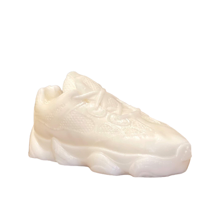 The Y500 – White Sneaker Candle – Large (On Backorder) is a hand-poured candle with visible laces and textured details, shown against a plain background.