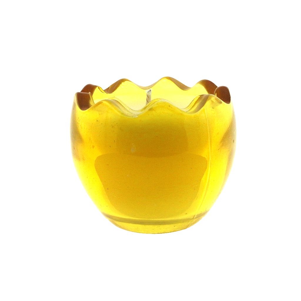 The Yellow Glass Easter Egg is a round, yellow glass candle holder with a wavy, scalloped rim that holds a lit natural wax candle inside.