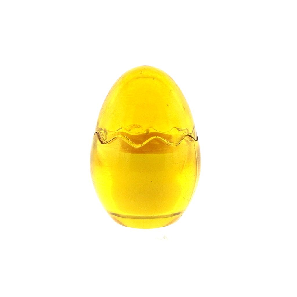 The Yellow Glass Easter Egg w/ Yoke is an egg-shaped yellow glass paperweight with a wavy line around its middle, reminiscent of an Easter egg candle, displayed against a white background.